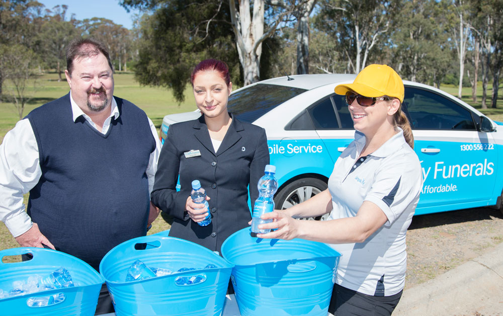 Simplicity funerals team handing out water bottles at an InvoCare Community Event